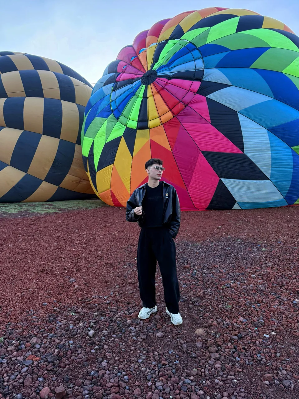 Brightly coloured balloons inflated on the gravel of the Teotihuacan launch field