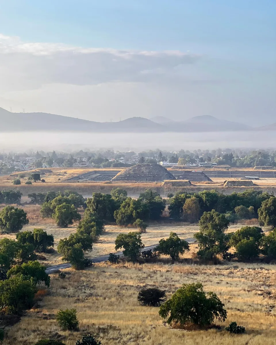 The launch field at dawn with the Teotihuacan pyramids on the horizon behind it, showing how far apart the two places are