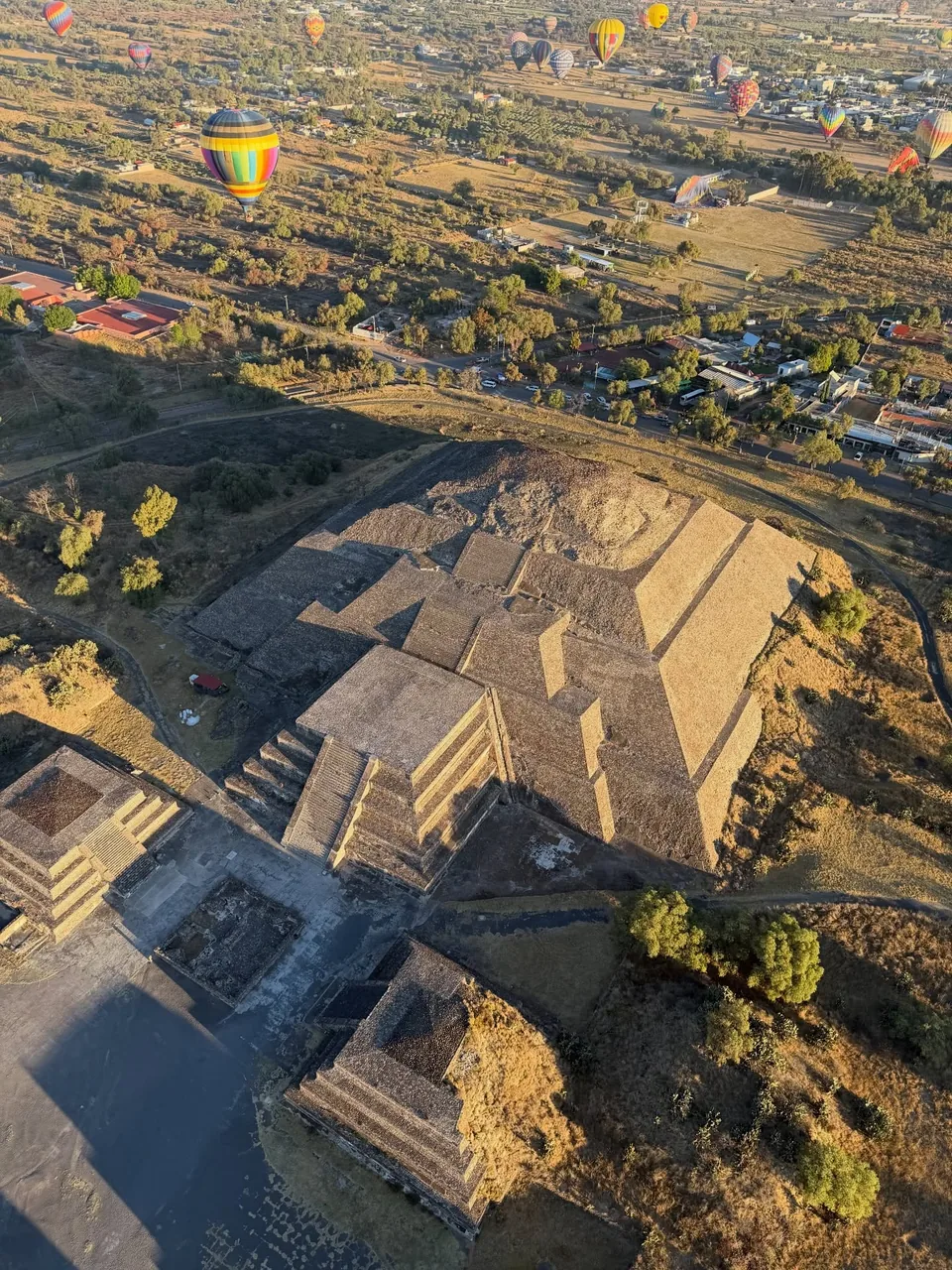 The Teotihuacan pyramids and the Avenue of the Dead seen from the air at dawn