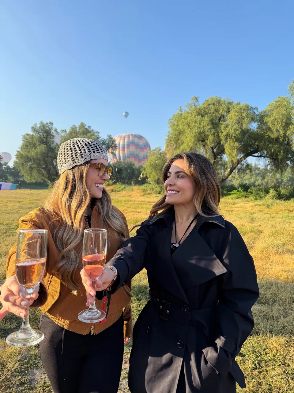 Two travelers toast with glasses in hand after landing near Teotihuacan
