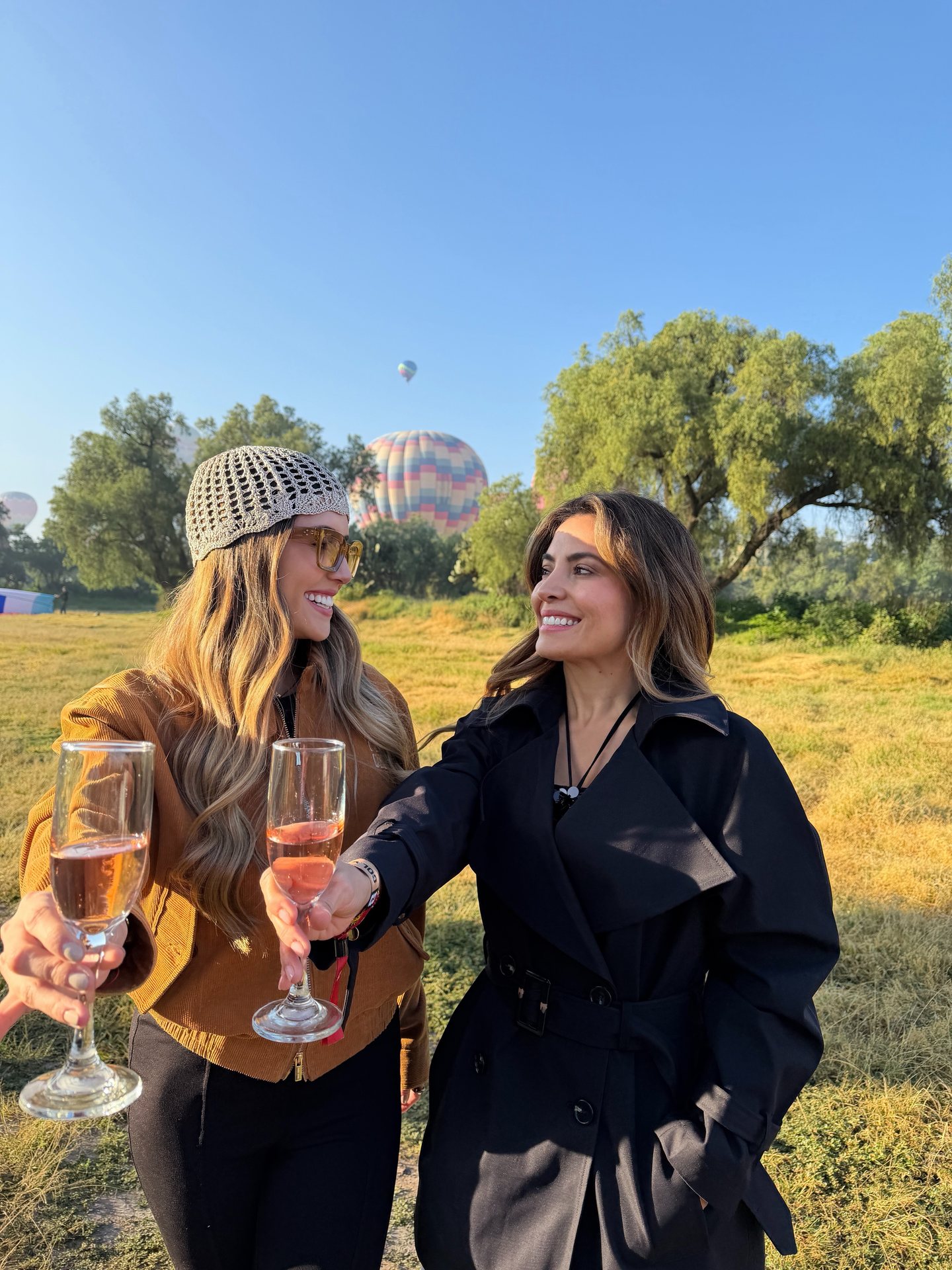 Two travelers toast with glasses in hand after landing near Teotihuacan